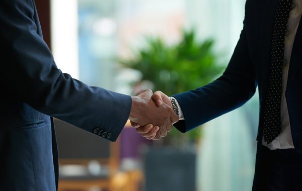 Firm handshake Business people shaking hands to confirm deal
